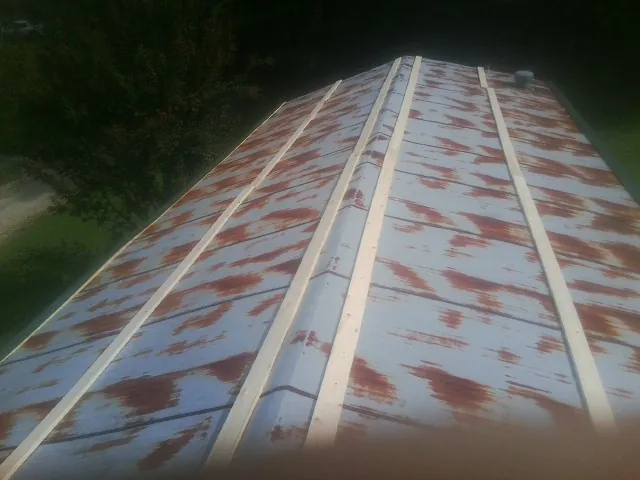Rusted metal roof panels with new wood purlins before replacement — Storm Damage Roof Repair in Lakeland by Roofing Brothers